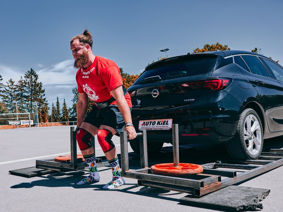 Ari Cohen competing in strongman - sled push event